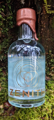 Bottle of Zenith gin lying on a mossy surface